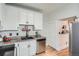 Efficient kitchen with white cabinets, stainless steel appliances, and stylish fixtures and wooden floor at 2564 N Emerson St, Denver, CO 80205
