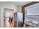 Bright kitchen featuring stainless steel refrigerator and exposed brick wall at 2564 N Emerson St, Denver, CO 80205