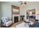Cozy living room with brick fireplace, hardwood floors, open to dining room with modern decor and blue sofa at 2564 N Emerson St, Denver, CO 80205