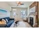 Cozy living room with a blue sofa, modern decor, a fireplace, and a bright window with a view at 2564 N Emerson St, Denver, CO 80205