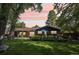 Lush backyard with mature trees and landscaping, creating a serene outdoor living space for the home at 13140 W 15Th Dr, Golden, CO 80401