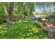 Spacious backyard with mature trees, lush lawn, and a charming patio at 13140 W 15Th Dr, Golden, CO 80401