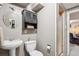 Cozy bathroom featuring a pedestal sink, mirror, and stall shower at 13140 W 15Th Dr, Golden, CO 80401
