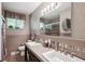 Spacious bathroom features a dual sink vanity, large mirror, and a shower at 13140 W 15Th Dr, Golden, CO 80401