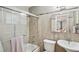 Bathroom features a shower and tub combination with glass door and tiled walls at 13140 W 15Th Dr, Golden, CO 80401