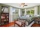 Bedroom showcasing green walls, hardwood floors, and natural light at 13140 W 15Th Dr, Golden, CO 80401