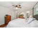 Bright bedroom featuring a ceiling fan, dresser, mirror, and en suite bathroom at 13140 W 15Th Dr, Golden, CO 80401