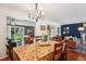 Bright dining room featuring wood floors, chandelier, and an open layout to the living room and backyard at 13140 W 15Th Dr, Golden, CO 80401