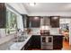 Well-appointed kitchen boasts stainless steel appliances, sleek countertops, ample cabinetry, and a bright window view at 13140 W 15Th Dr, Golden, CO 80401