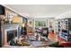 Elegant living room showcasing a fireplace, large window with backyard view, and beautiful hardwood floors at 13140 W 15Th Dr, Golden, CO 80401