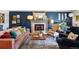 Stylish living room featuring a fireplace, elegant decor, and comfortable seating, perfect for relaxing and entertaining at 13140 W 15Th Dr, Golden, CO 80401
