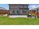 Backyard featuring a patio, lounge furniture, grass, and an exterior view of the home at 76 N Ider St, Aurora, CO 80018