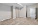 Finished basement area with carpet, base trim, gray paint, and view into another room at 76 N Ider St, Aurora, CO 80018