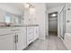 Bright bathroom with white cabinets, granite counters, and a glass shower at 76 N Ider St, Aurora, CO 80018