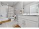 Clean bathroom featuring a tub, shower and modern vanity at 76 N Ider St, Aurora, CO 80018