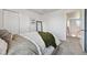 Neutral bedroom featuring plush bedding and a glimpse into the hallway at 76 N Ider St, Aurora, CO 80018