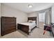 Comfortable bedroom with wood furniture, soft lighting, and a cozy atmosphere at 76 N Ider St, Aurora, CO 80018