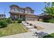 Inviting two-story home featuring a stone facade, three-car garage, and manicured landscaping at 76 N Ider St, Aurora, CO 80018