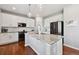 Modern kitchen featuring white cabinetry, stainless steel appliances, and a granite-topped island at 76 N Ider St, Aurora, CO 80018