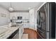 Modern kitchen featuring white cabinetry, stainless steel appliances, and a granite-topped island at 76 N Ider St, Aurora, CO 80018