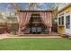 Backyard pergola featuring outdoor seating area, hot tub, and manicured landscaping at 263 N Logan St, Denver, CO 80203