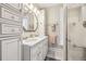 Bright bathroom featuring double vanity, custom cabinets, and glass enclosed shower at 263 N Logan St, Denver, CO 80203