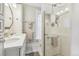 Elegant bathroom featuring a double sink vanity, modern fixtures, and a glass-enclosed shower with decorative tiles at 263 N Logan St, Denver, CO 80203