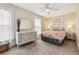Cozy bedroom with a decorative mirror, ceiling fan, and comfortable bed with floral bedding and bedside tables at 263 N Logan St, Denver, CO 80203