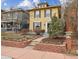 Charming yellow two-story home with a well-maintained front yard and classic architectural details at 263 N Logan St, Denver, CO 80203