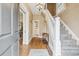 Inviting foyer with hardwood floors, a staircase with carpet runner, and a view into other rooms at 263 N Logan St, Denver, CO 80203