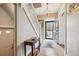 Foyer featuring hardwood floors, a decorative table, staircase, and an ornate door at 263 N Logan St, Denver, CO 80203