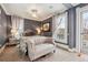 Cozy main bedroom featuring seating, large window and ceiling fan at 263 N Logan St, Denver, CO 80203