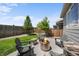 Backyard with fire pit, Adirondack chairs, wooden privacy fence, and lawn at 3575 White Rose Loop, Castle Rock, CO 80108