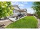 Lush backyard with covered patio, grill, and comfortable seating area, perfect for outdoor entertaining at 3575 White Rose Loop, Castle Rock, CO 80108