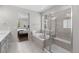 Luxurious bathroom featuring a soaking tub, a separate shower, and access to the primary bedroom at 3575 White Rose Loop, Castle Rock, CO 80108