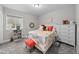 Bright, cozy bedroom featuring white furniture, colorful accents, and a well-organized bookshelf at 3575 White Rose Loop, Castle Rock, CO 80108