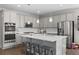 Beautiful kitchen with gray cabinetry, stainless appliances, large island, and stylish backsplash, perfect for cooking at 3575 White Rose Loop, Castle Rock, CO 80108