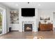 Cozy living room with a fireplace and built-in shelves, perfect for relaxation and entertaining guests at 3575 White Rose Loop, Castle Rock, CO 80108