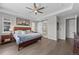 Spacious main bedroom with a ceiling fan, large windows, and an ensuite bathroom with a barn door entrance at 3575 White Rose Loop, Castle Rock, CO 80108