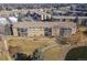 Aerial view of building with mature trees, landscaping, walking path and pond at 13618 E Bethany Pl # 306, Aurora, CO 80014