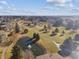 Scenic aerial view of the complex showcasing the pond, fountain and lush surrounding landscape at 13618 E Bethany Pl # 306, Aurora, CO 80014