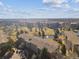 Aerial view of the property showcasing the building, golf course, pond, and surrounding landscape at 13618 E Bethany Pl # 306, Aurora, CO 80014