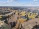 Aerial view of community near golf course, pond, and mature trees at 13618 E Bethany Pl # 306, Aurora, CO 80014