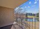 Serene balcony view overlooking a pond, golf course, and lush greenery on a sunny day at 13618 E Bethany Pl # 306, Aurora, CO 80014