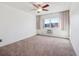 Bedroom with carpet, a window and window-mounted air conditioner at 13618 E Bethany Pl # 306, Aurora, CO 80014