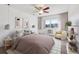Bright bedroom featuring a ceiling fan, large window with natural light, and comfortable seating area at 13618 E Bethany Pl # 306, Aurora, CO 80014