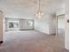 Bright living room with carpeting, sliding doors to balcony, and large mirror closet at 13618 E Bethany Pl # 306, Aurora, CO 80014