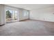 Spacious living room featuring carpet, large sliding glass door to balcony and large windows at 13618 E Bethany Pl # 306, Aurora, CO 80014