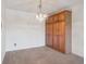 Living room featuring built-in cabinets, a decorative light fixture, and a neutral color palette at 13618 E Bethany Pl # 306, Aurora, CO 80014