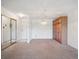 Living room featuring mirrored closet doors, a decorative light fixture and ample room for furniture at 13618 E Bethany Pl # 306, Aurora, CO 80014